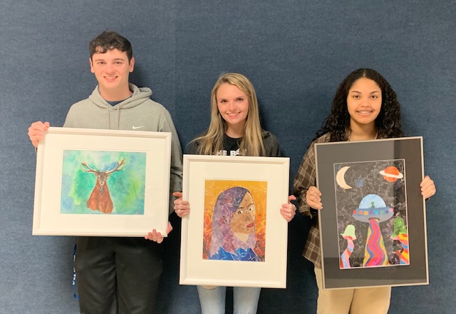 Students showing off their artwork for the TRAHC: 
Zander Capps (left) with
"Winter Breeze" 
(a watercolor and acrylic), Madison McCall (middle) with
"Watch Me Burn"
(a mixed media), and Jaidyn Henderson (right) with
"Invasion"
(a mixed media)